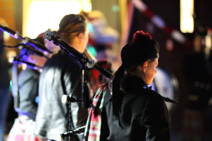 Mitglieder der Pipeband im Gegenlicht bei einem Auftritt